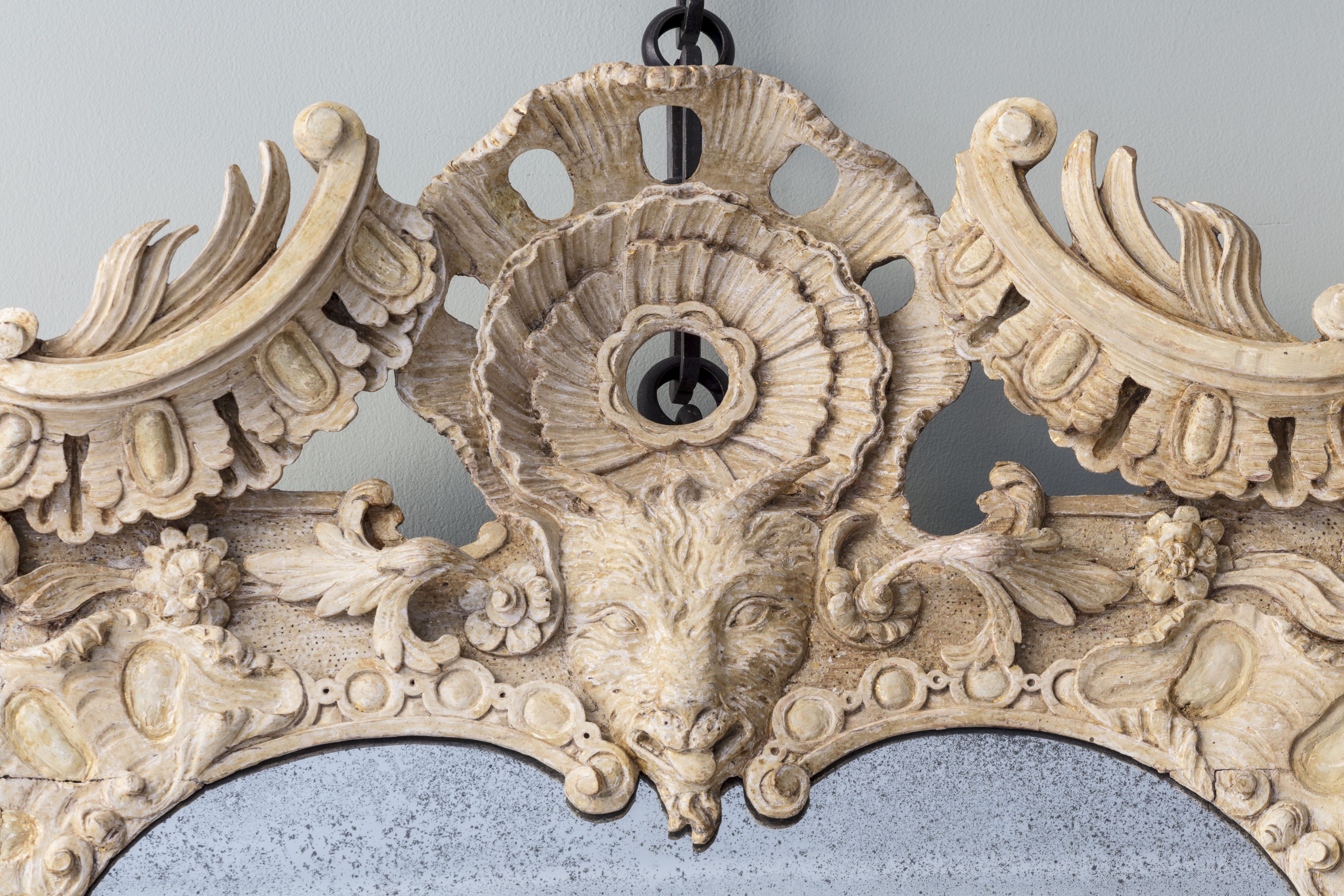 Detail of the central goat mask, within scolling cornucopia and acanthus border.