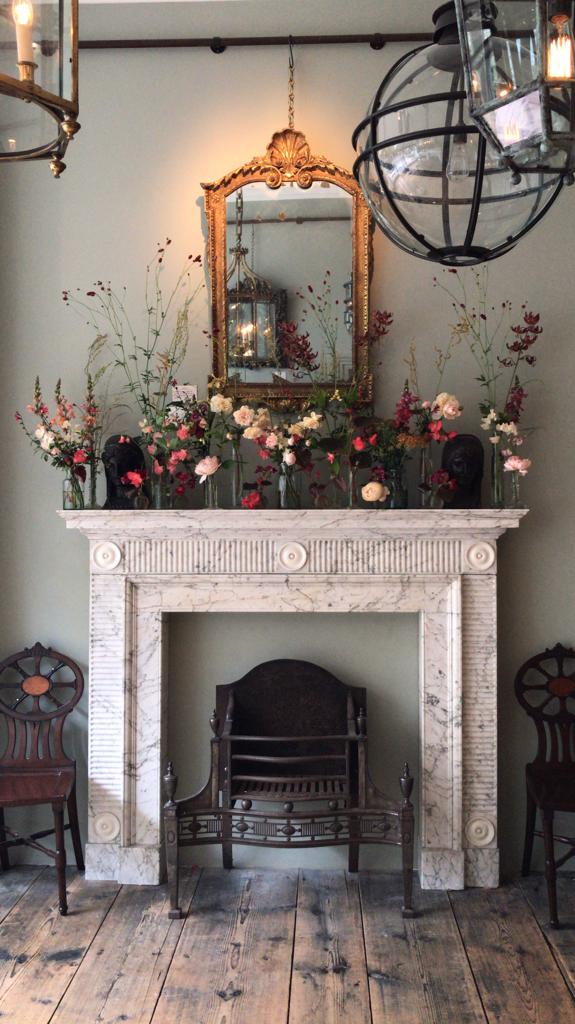 Shane Connolly's beautiful arrangements adorn the Jamb reproduction Waldorf mantel.