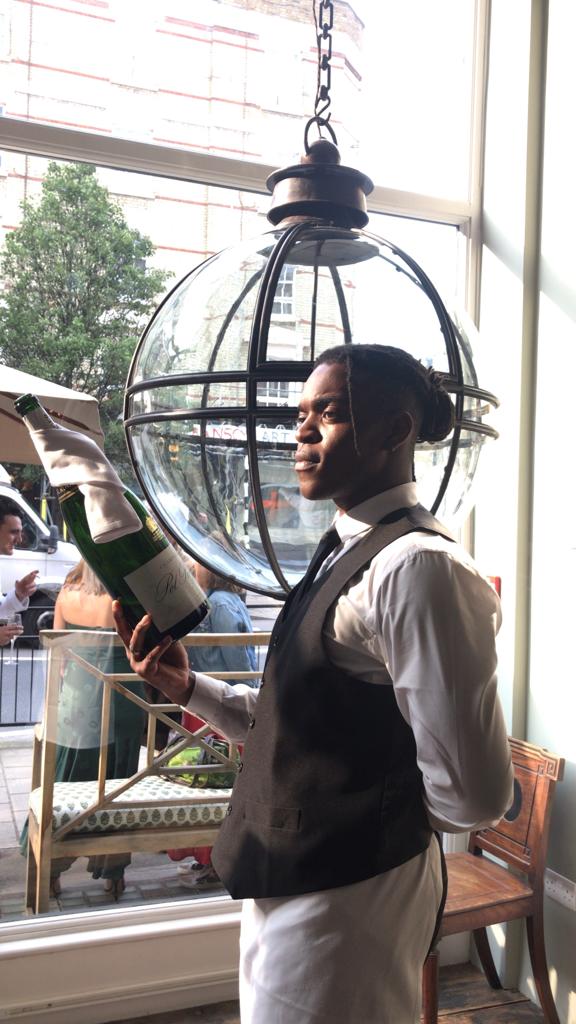 A magnum of champagne accompanies an extra large Jamb globe lantern