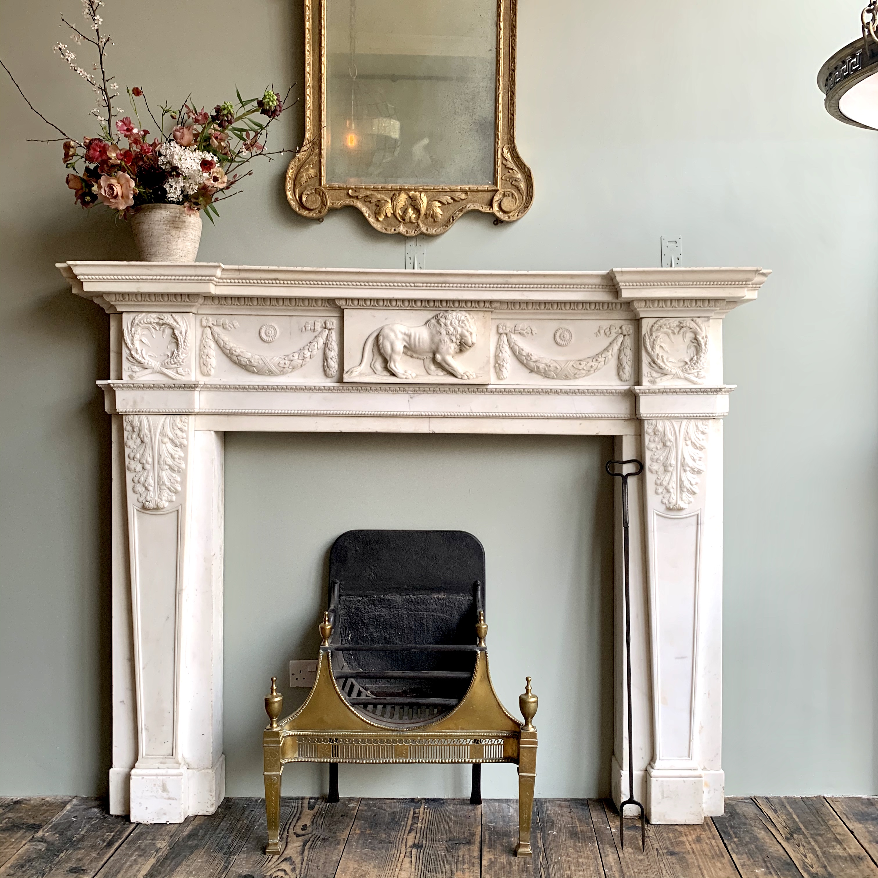 A magnificent statuary marble mid-18th century chimneypiece bearing an exquisitely carved lion on the central tablet.