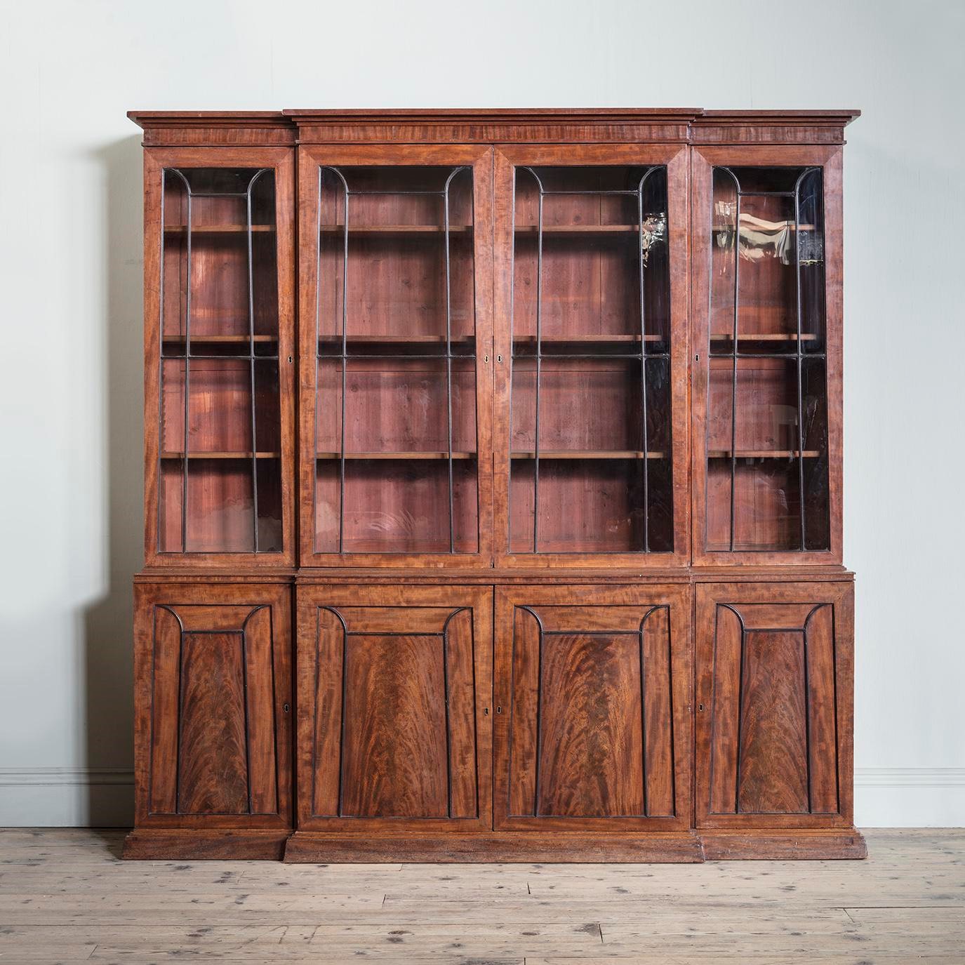 A fine Early 19th Century Mahogany Egyptian Revival Breakfront Bookcase, in the manner of George Smith.