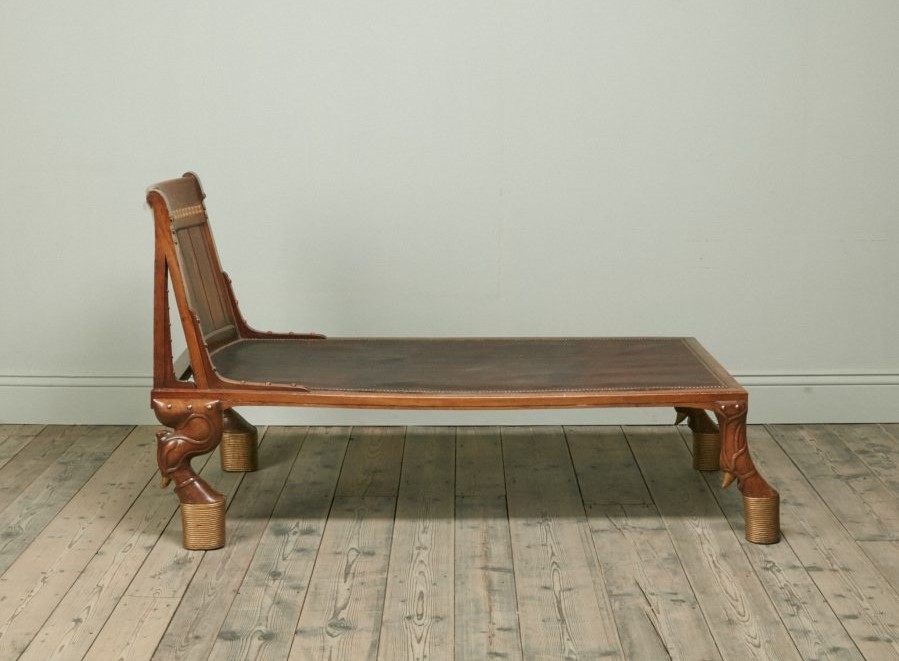 A Spectacular Nineteenth Century Walnut Egyptian Revival Day Bed With geometric inlay and accentuated stimulated rope bound hoof feet.